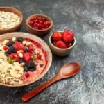 Healthy oatmeal breakfast bowl topped with walnuts, fresh blueberries and chia seeds for supporting brain, heart and gut health.